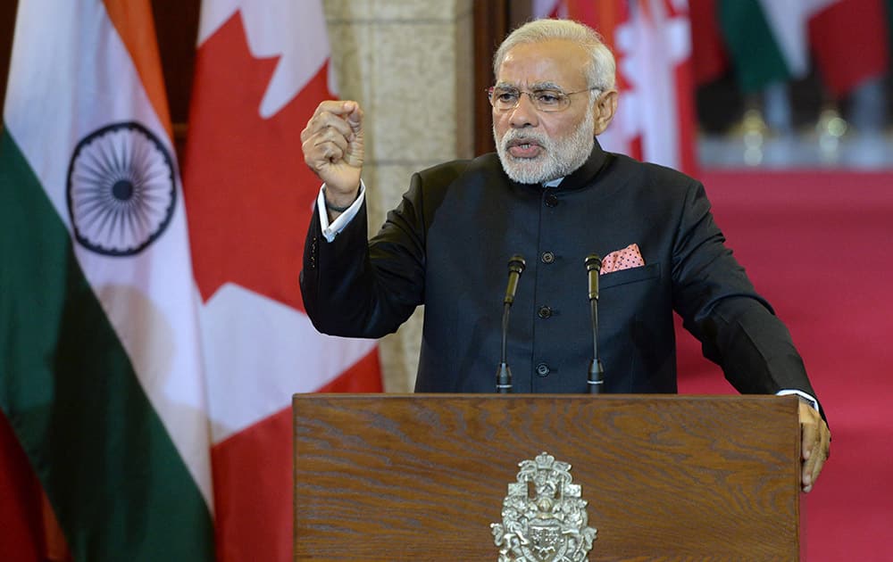 Prime Minister Narendra Modi speaks during a joint press conference with Prime Minister Stephen Harper on Parliament Hill in Ottawa.