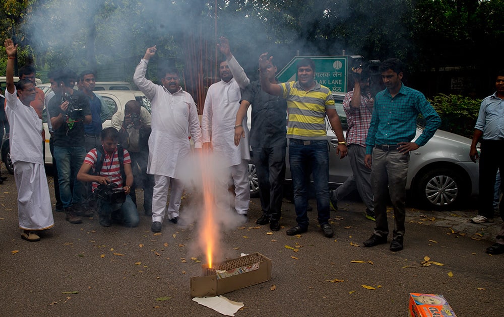 Congress party supporters light crackers outside the residence of their leader Rahul Gandhi as they celebrate his return from holidays in New Delhi.