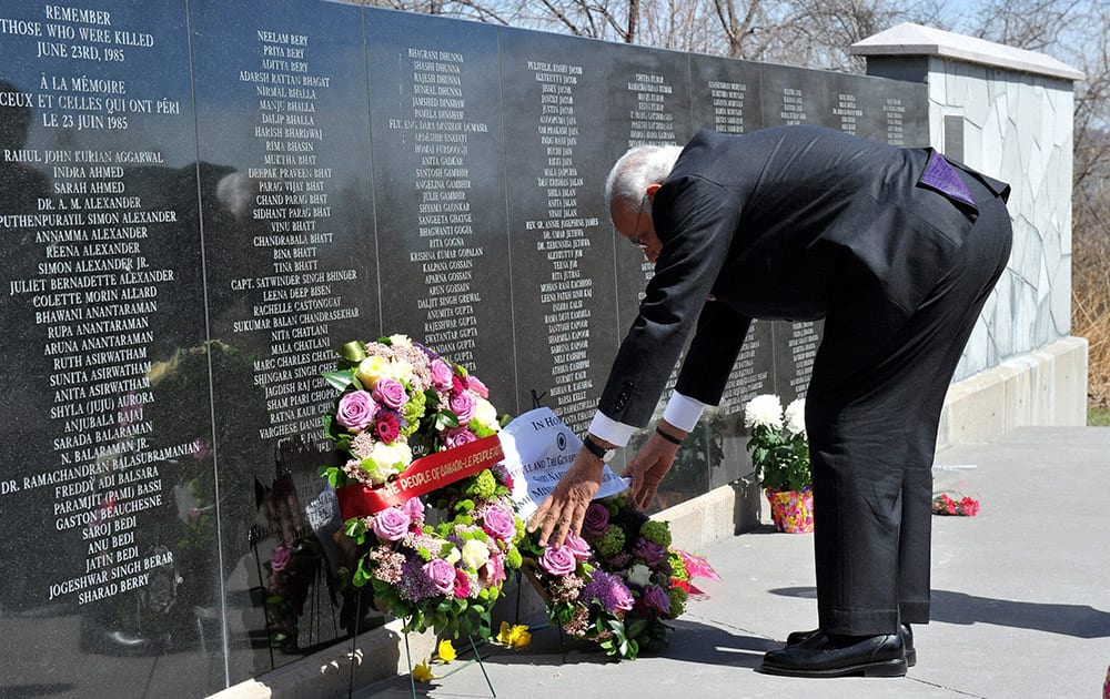 Canadian Prime Minister Stephen Harper, watches PM Narendra Modi lay a wreath down as they visit the memorial site for victims of the 1985 Air India bombing in Toronto.