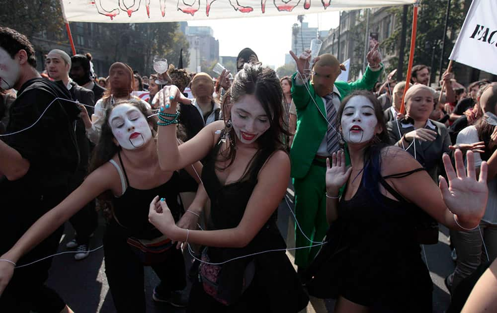 Youths participate in a protest march in Santiago, Chile.