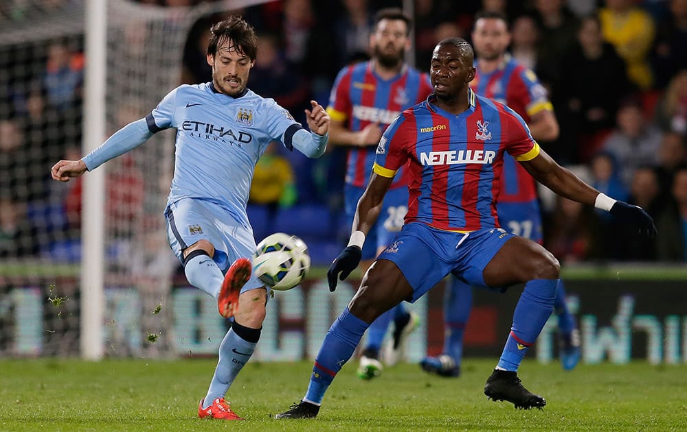 Manchester City’s David Silva competes for the ball with Crystal Palace's Yannick Bolasie during the English Premier League soccer match between Crystal Palace and Manchester City at Selhurst Park Stadium, London.