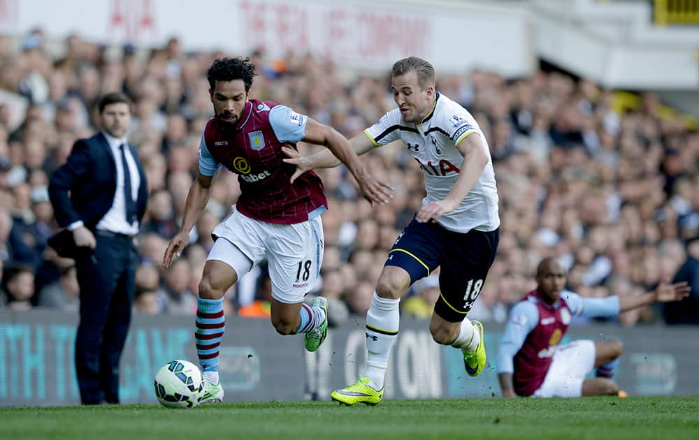 Tottenham Hotspur's Harry Kane, competes for the ball with Aston Villa's Kieran Richardson during the English Premier League soccer match between Tottenham Hotspur and Aston Villa at White Hart Lane stadium in London.