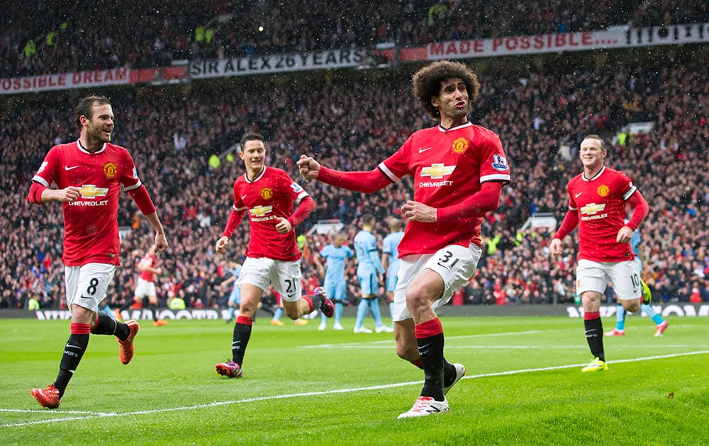 Manchester United's Marouane Fellaini, celebrates after scoring during the English Premier League soccer match between Manchester United and Manchester City at Old Trafford Stadium.