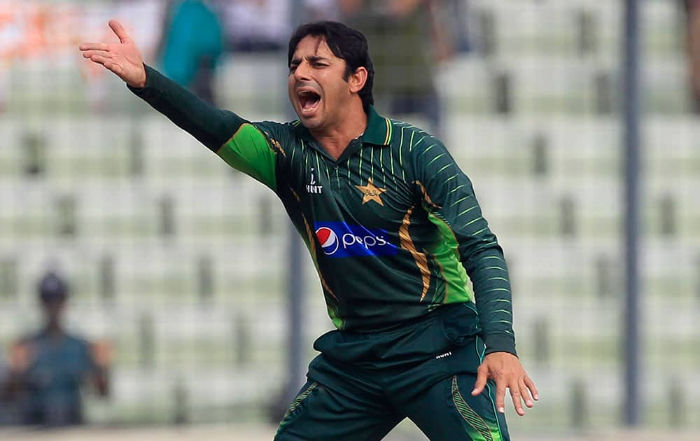 Pakistan’s Saeed Ajmal reacts after Bangladesh's Tamim Iqbal played a shot off his bowling during their first one-day international cricket match against Bangladesh, in Dhaka.