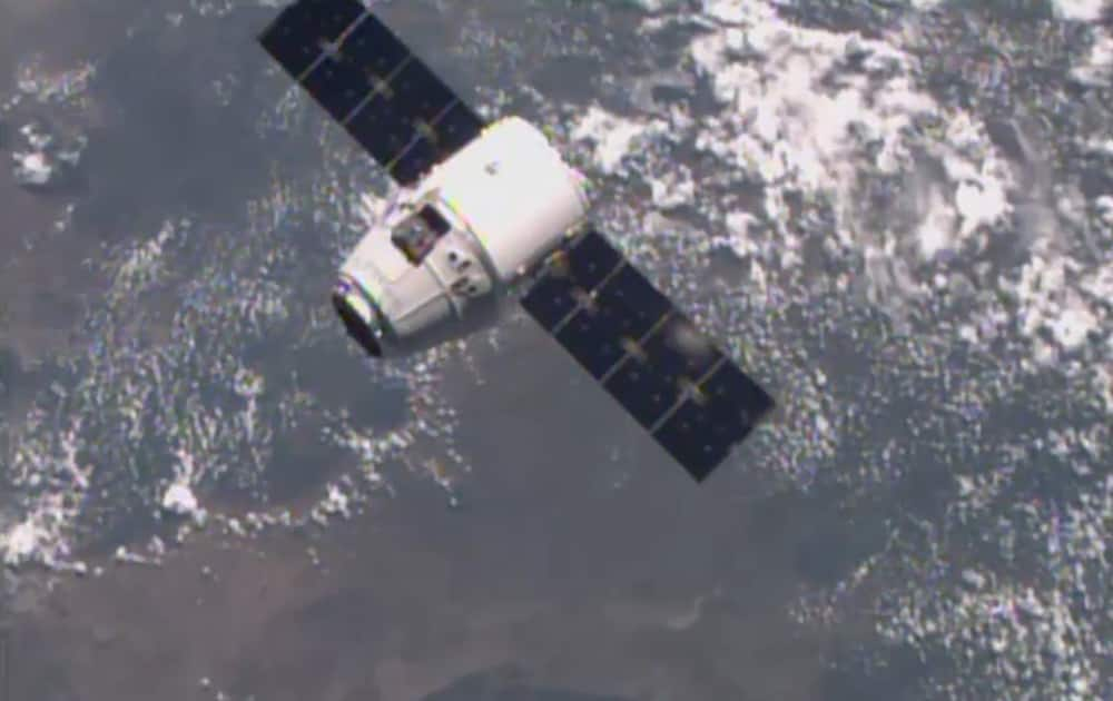 This image from NASA-TV shows the SpaceX Dragon-6 resupply capsule, as it holds 30 meters from the International Space Station as they cross over the coast of Namibia.