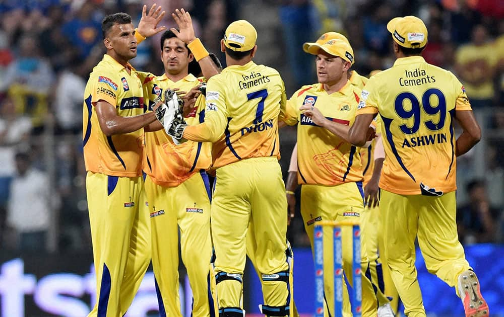 Chennai Super Kings bowler Ishwar Pandey celebrates with teammates the wicket of Mumbai Indians batsman Simmons during their IPL T20 match in Mumbai.