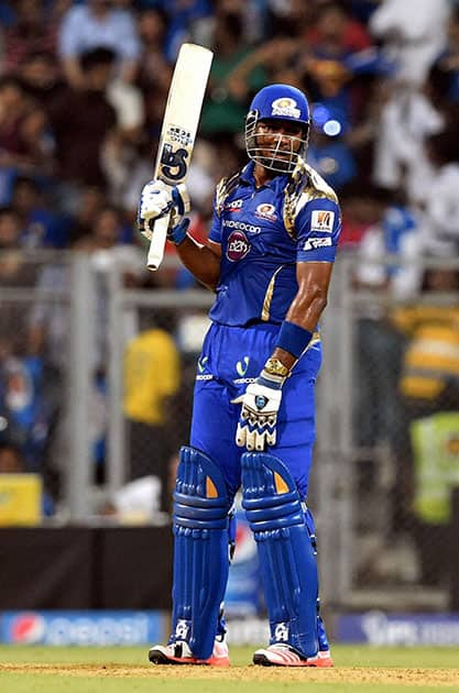 Mumbai Indians batsman K Pollard raise his bat after completes his half century against Chennai Super Kings during a IPL T20 match in Mumbai.