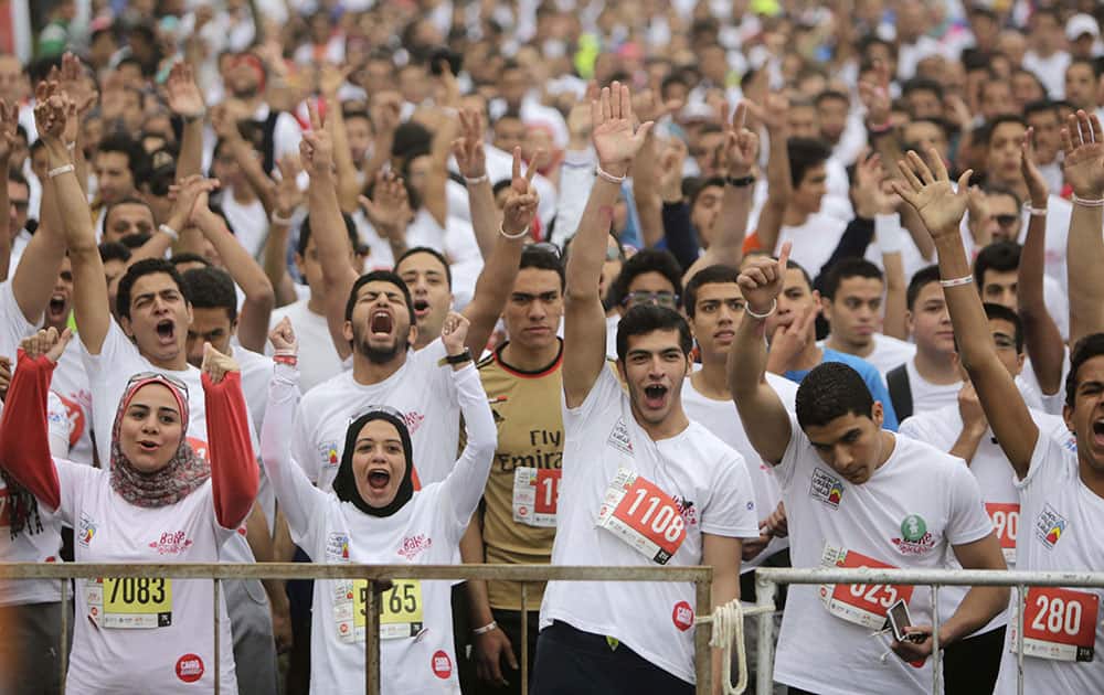 Egyptian runners warm up before they participate in Cairos annual Half Marathon in the Heliopolis district in Cairo, Egypt.