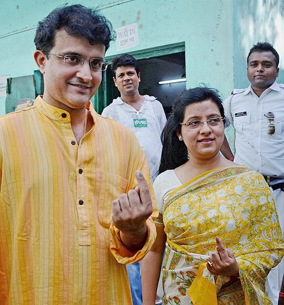 Former cricket captain Sourav Ganguly with his wife Dona Ganguly (R) after casting their votes during Municipal Corporation elections in Kolkata.