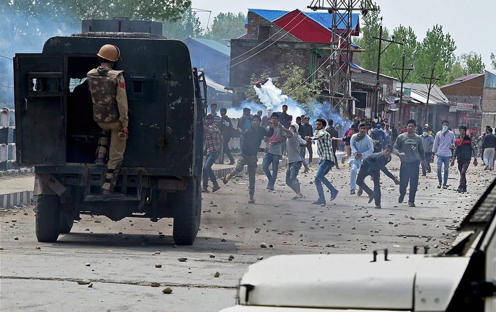 Police Personnel attempt to control the clashes which erupted after the killing of a youth in Narbal as angry protesters continue to pelt stones at them in Srinagar.