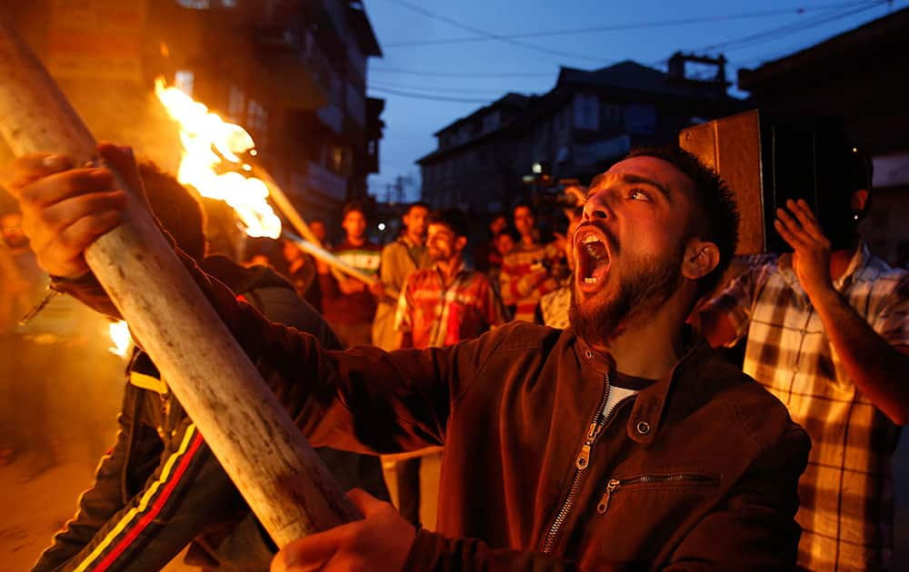 Activists of Jammu and Kashmir Liberation Front (JKLF) shout freedom slogans as they participate in a torch light procession in Srinagar, India.