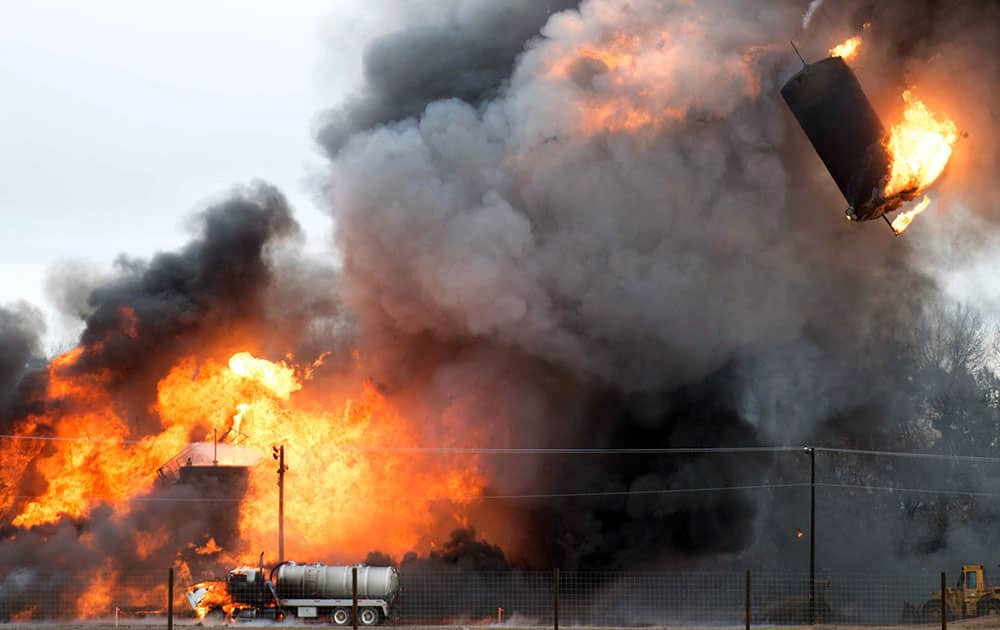 An oil and gas waste water tank soars through the sky after an explosion near the Greeley-Weld Airport in Greeley, Colo.