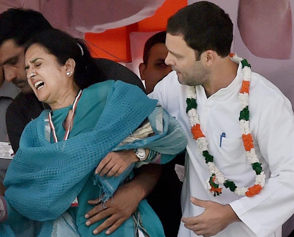  Congress Vice President Rahul Gandhi helps Haryana Congress leader Kiran Chaudhary off the stage after she stumbled and hurt herself during the farmers rally at Ramlila Maidan in New Delhi.