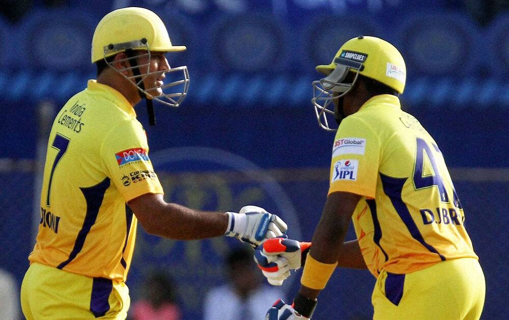 Mahendra Singh Dhoni and Dwayne Bravo shake hands during a match between Rajasthan Royals and Chennai Super Kings in Ahmedabad.