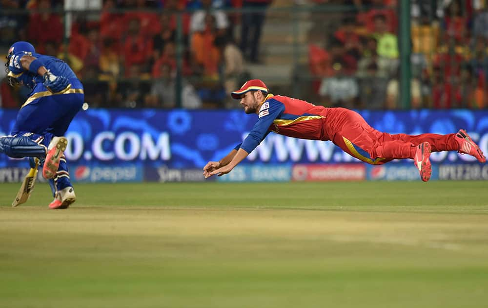 Mumbai Indians Lendl Simmons runs to reach on the crease as Rilee Rossouw throws the ball against Royal Challengers Bangalore during IPL 8 match at Chinnaswamy Stadium in Bengaluru.