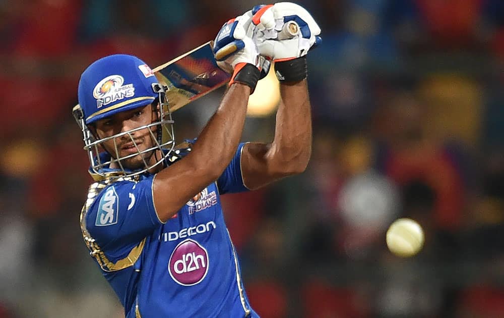 Mumbai Indians Unmukt Chand plays a shot against Royal Challengers Bangalore during IPL 8 match in Bengaluru.