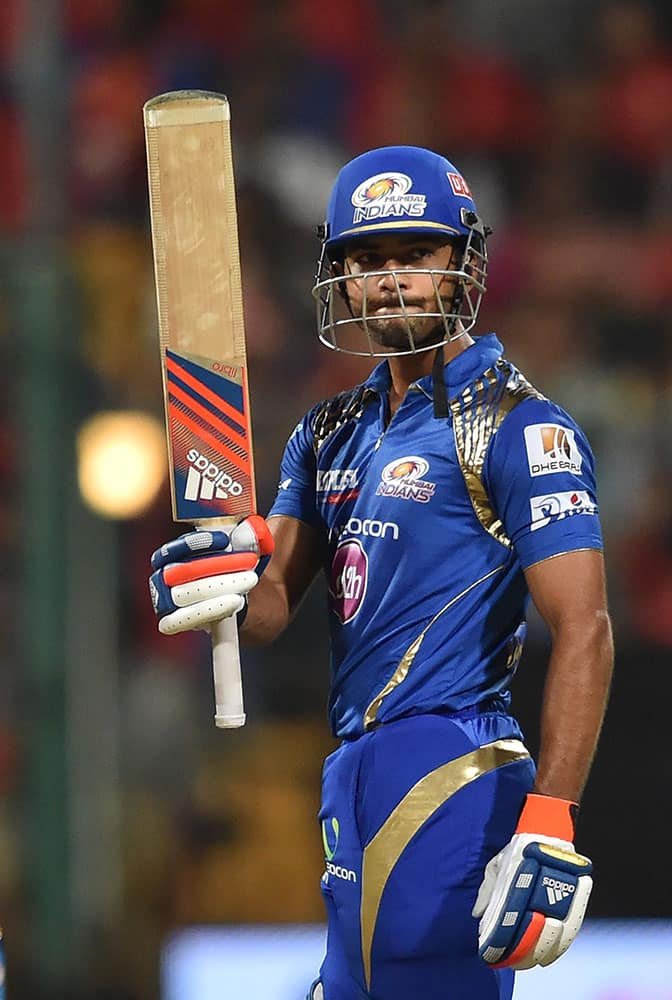 Mumbai Indians Unmukt Chand celebrates his fifty runs against Royal Challengers Bangalore during IPL 8 match in Bengaluru.