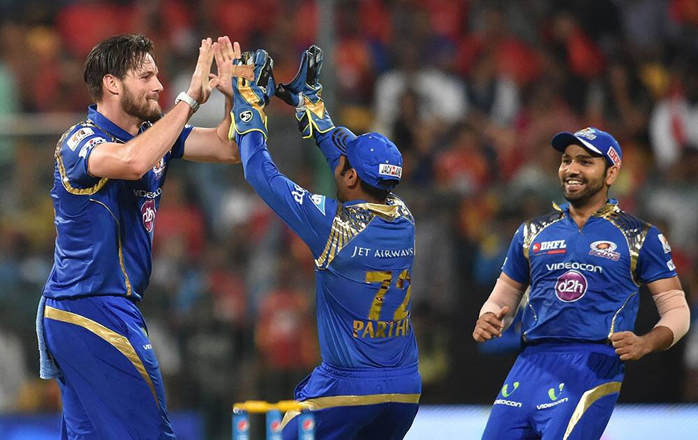 Mumbai Indians Mitchell McCleanaghan celebrates the wicket of Virat Kohli of RCB during IPL 8 match at Chinnaswamy Stadium in Bengaluru.