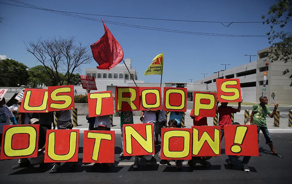 Filipino activists hold slogans during a rally in front of the U.S. embassy in Manila, Philippines. The group is protesting against a joint U.S.-Philippines military exercise dubbed 