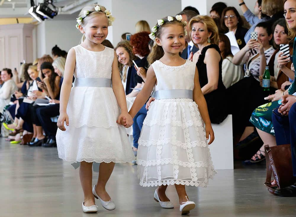 models wear creations from the Oscar de la Renta Bridal Spring 2016 collection in New York. Peter Copping, hired last October as artistic director of the luxury label, retained much of the classic de la Renta glamour but added a few more modern-looking silhouettes, some new takes on fabric work, and some silvery sequins.