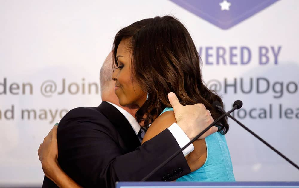 First lady Michelle Obama hugs New Orleans Mayor Mitch Landrieu at an event honoring efforts to help homeless veterans, in New Orleans.