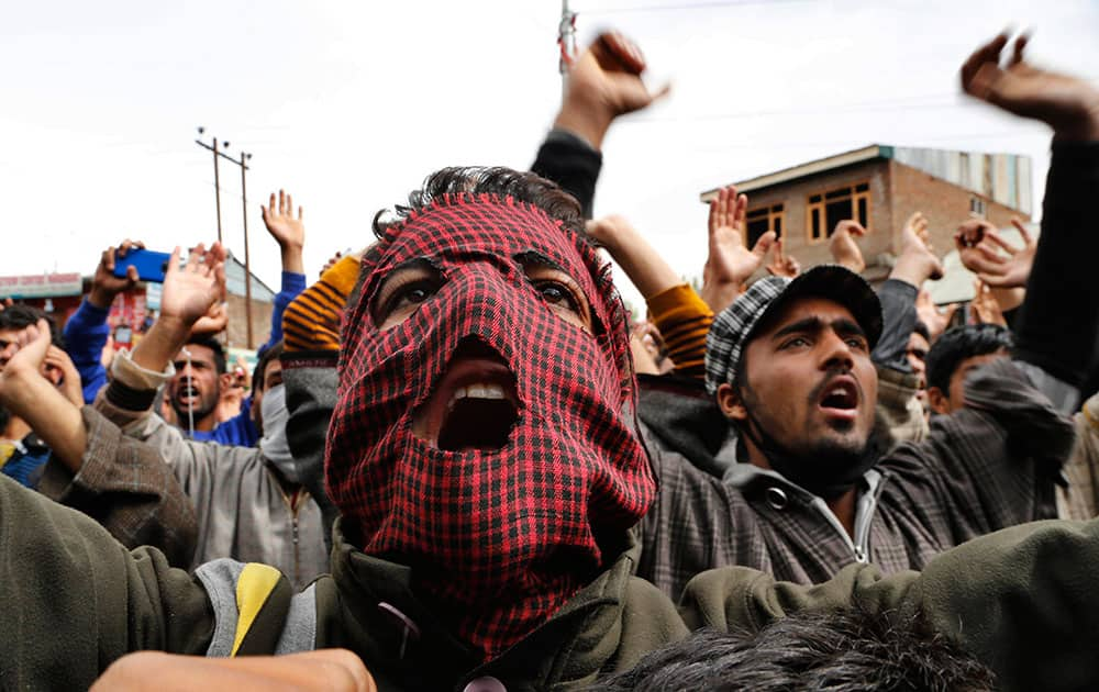 Kashmiri protesters shout slogans during during a protest against the killing of a teenage boy in Narbal, some 15 Kilometers (10 miles) west of Srinagar, India.