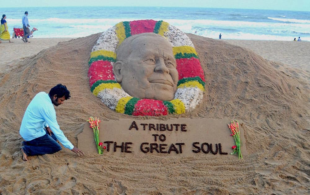 Sand artist Sudarsan Pattnaik creates a sand sculpture to pay tribute Odishas former chief minister JB Pattanaik at Puri beach.