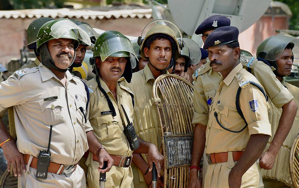 Security personnel guard during Aam Aadmi Party (AAP)s rally against the Union governments Land Acquisition Bill at Jantar Mantar in New Delhi.