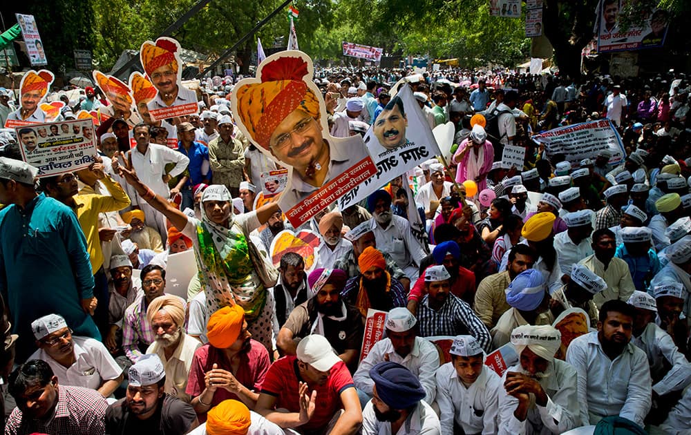 Farmers and Aam Aadmi Party supporters display pictures of Delhi Chief Minister leader Arvind Kejriwal at a rally near the parliament in New Delhi.