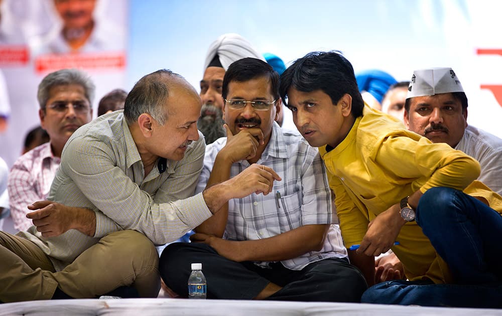 Delhi Chief Minister Arvind Kejriwal sits flanked by Aam Aadmi Party leaders Manish Sisodia and Kumar Vishwas at a farmer’s rally near the parliament in New Delhi.