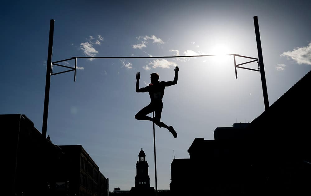 Pole vaulter Karsten Dilla, of Germany, clears the bar in the Drake Relays Street Vault, in downtown Des Moines, Iowa. 