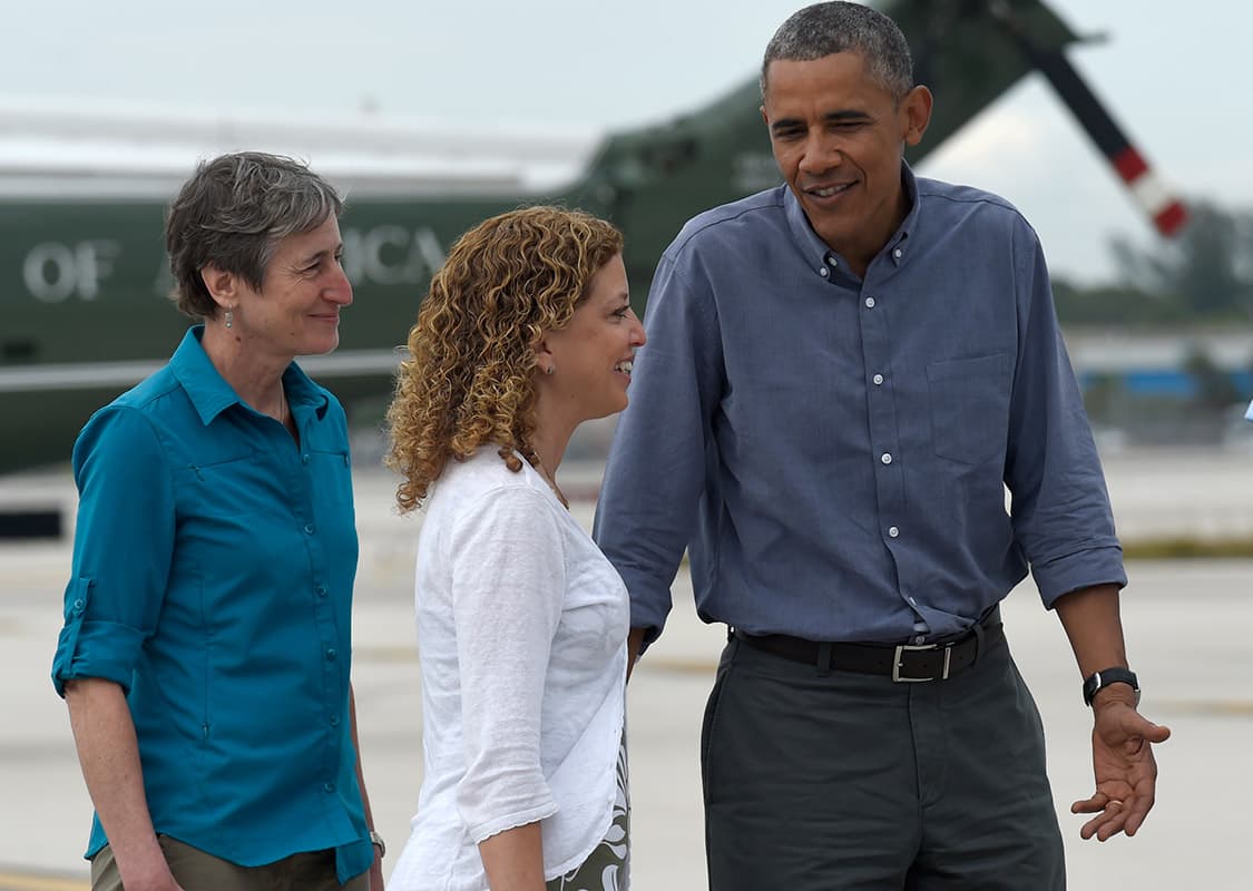 President Barack Obama walks towards Air Force One with Rep. Debbie Wasserman Schultz, D-Fla., center, and Interior Secretary Sally Jewell , left, after arriving on Marine One at Miami's International Airport.