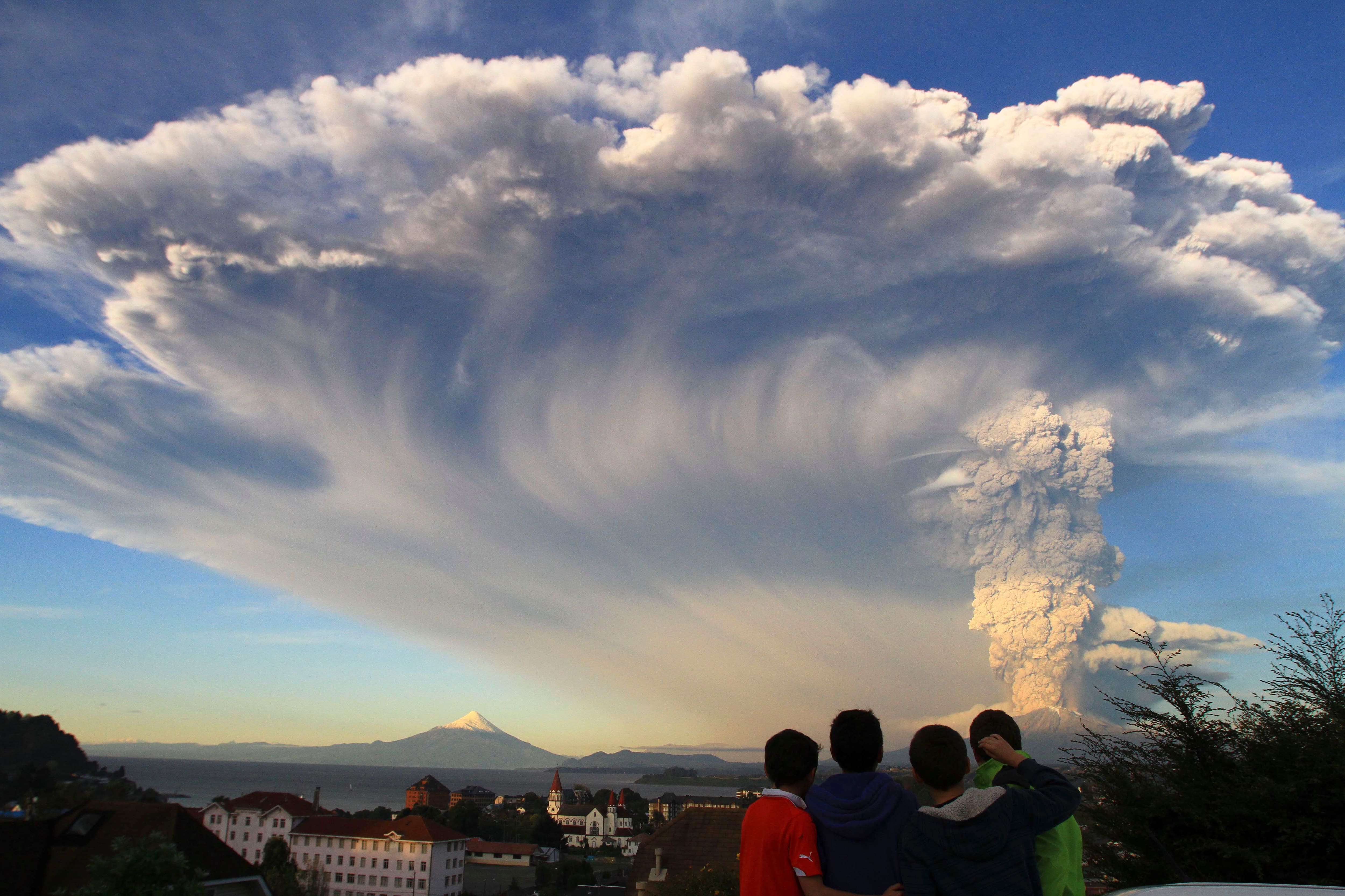 Children watch the Calbuco volcano erupt, from Puerto Varas, Chile.