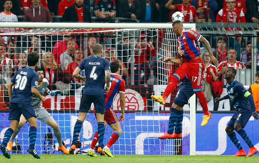 Bayern's Jerome Boateng, second right, scores his side's 2nd goal during the soccer Champions League quarterfinal second leg match between Bayern Munich and FC Porto at the Allianz Arena in Munich, southern Germany.