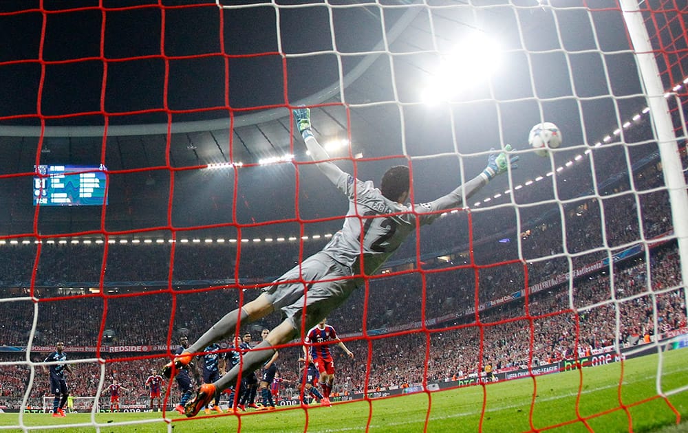 Porto's goalkeeper Fabiano Freitas fails to make a save as Bayern's Xabi Alonso scores his side's sixth goal during the soccer Champions League quarterfinal second leg match between Bayern Munich and FC Porto at the Allianz Arena in Munich, southern Germany.