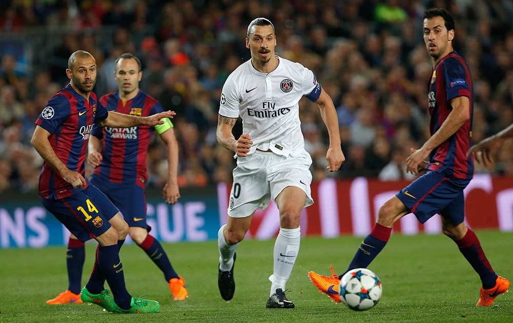 PSG's Zlatan Ibrahimovic, centre, is surrounded Barcelona's Javier Mascherano, left, and Sergio Busquets during the Champions League quarterfinal second leg soccer match between FC Barcelona and Paris Saint Germain at the Camp Nou Stadium in Barcelona, Spain.