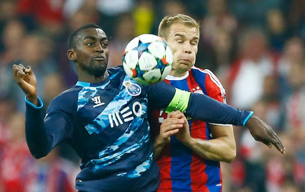 Porto's Jackson Martinez, left, and Bayern's Holger Badstuber challenge for the ball during the soccer Champions League quarterfinal second leg match between Bayern Munich and FC Porto at the Allianz Arena in Munich, southern Germany.