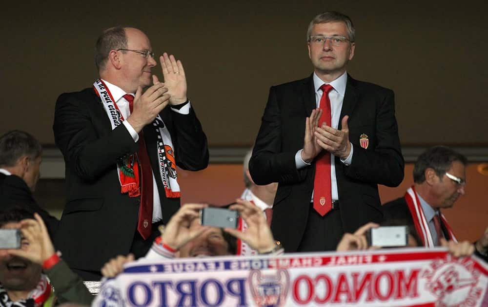 Prince Albert II of Monaco and president of AS Monaco Dmitry Rybolovlev cheer their team before the Champions League quarterfinal second leg soccer match between Monaco and Juventus at Louis II stadium in Monaco.