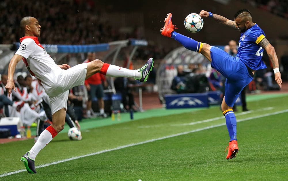 Monaco's Fabinho is challenged by Juventus' Arturo Vidal during the Champions League quarterfinal second leg soccer match between Monaco and Juventus at Louis II stadium in Monaco.