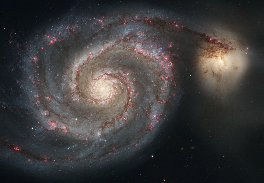 This image made by the NASA/ESA Hubble Space Telescope shows the Whirlpool Galaxy (M51) and a companion galaxy. The Whirlpool's two curving arms are star-formation factories, compressing hydrogen gas and creating clusters of new stars. The Hubble Space Telescope marks its 25th anniversary.