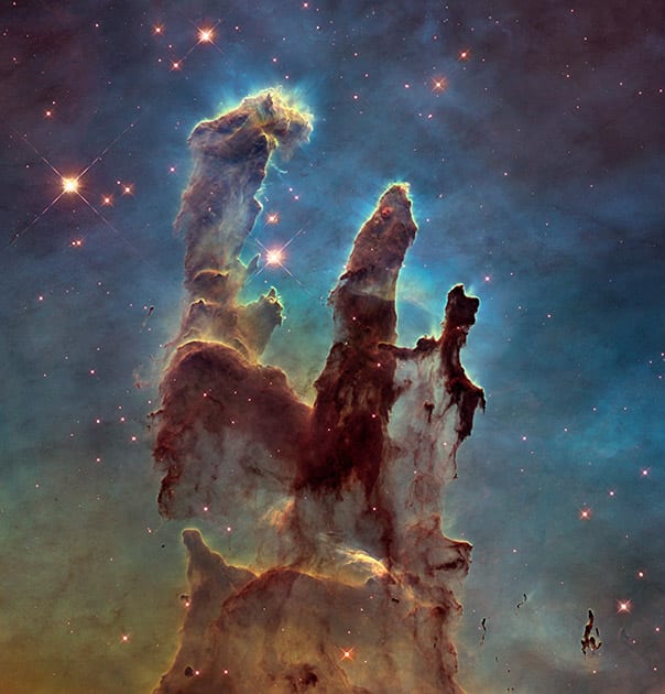 This image made by the NASA/ESA Hubble Space Telescope shows the Eagle Nebula's 'Pillars of Creation.' The dust and gas in the pillars is seared by the intense radiation from young stars and eroded by strong winds from massive nearby stars. The Hubble Space Telescope marks its 25th anniversary.