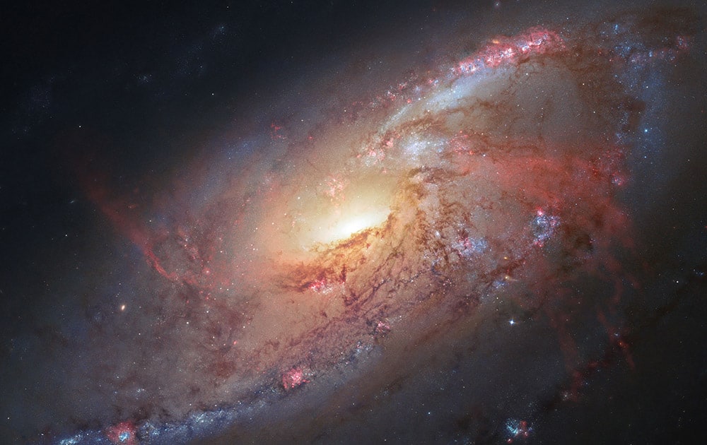 This image made by the NASA/ESA Hubble Space Telescope shows M106 with additional information captured by amateur astronomers Robert Gendler and Jay GaBany. Gendler combined Hubble data with his own observations to produce this color image. It is a relatively nearby spiral galaxy, a little over 20 million light-years away. The Hubble Space Telescope marks its 25th anniversary.