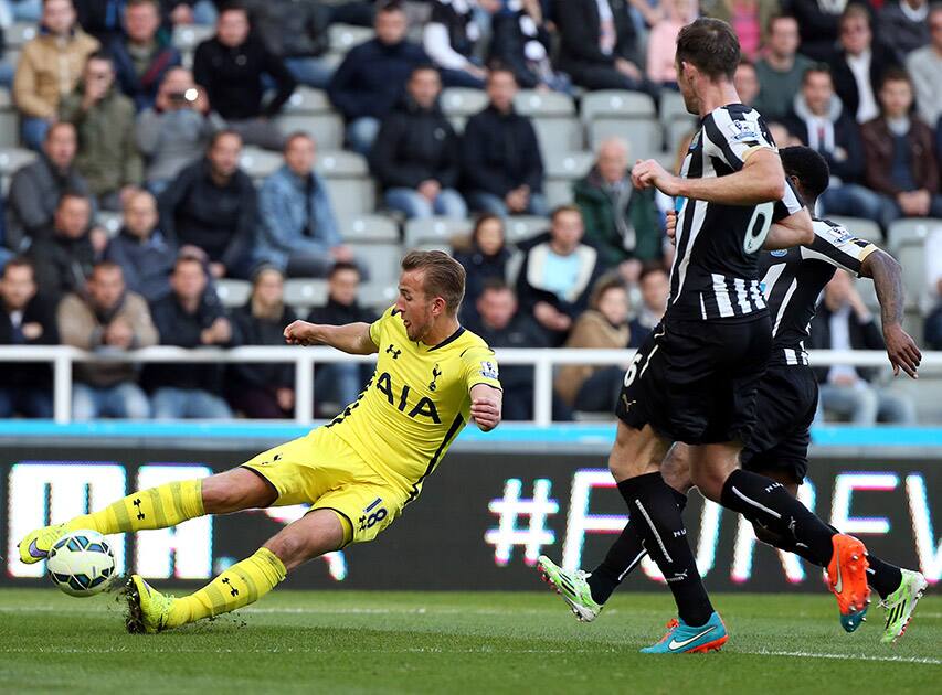 Tottenham Hotspur's Harry Kane, left, vies for the ball with Newcastle United's Mike Williamson, right, during their English Premier League soccer match between Newcastle United and Tottenham Hotspur at St James' Park, Newcastle, England.