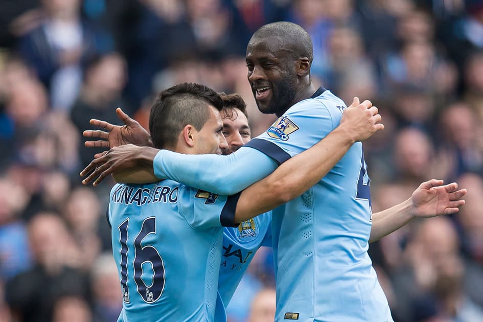 Manchester City's Sergio Aguero, left, celebrates with teammates Jesus Navas and Yaya Toure, right, after scoring against West Ham United's during the English Premier League soccer match between Manchester City and West Ham United at the Etihad Stadium, Manchester, England.