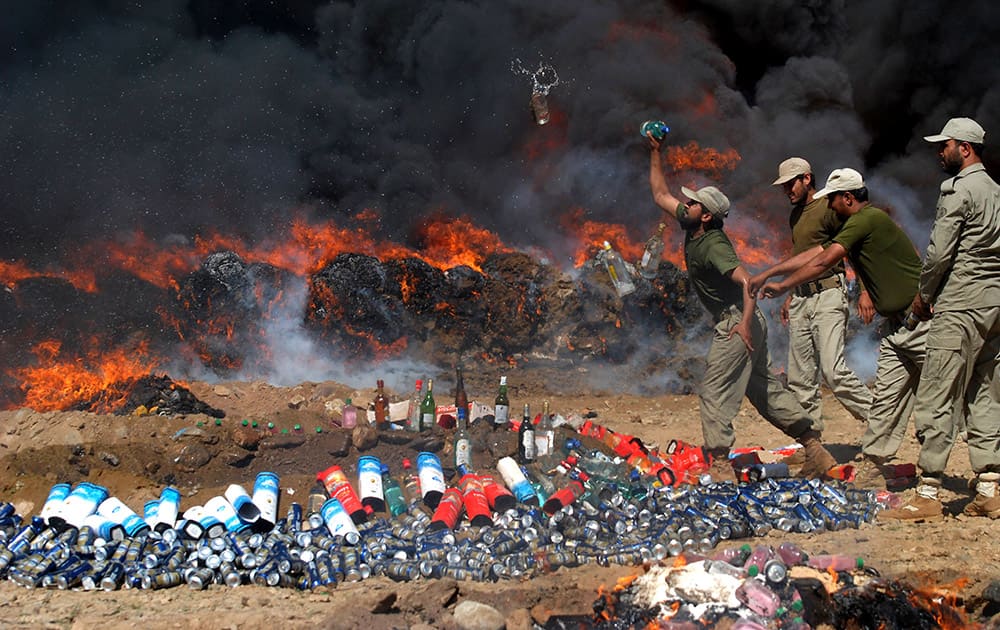 Pakistani officials of the Anti-Narcotic Control Force burn seized drugs and liquor, in Peshawar, Pakistan. Pakistan is taking strict measures to stop drug trafficking from neighboring Afghanistan and Pakistani tribal areas.