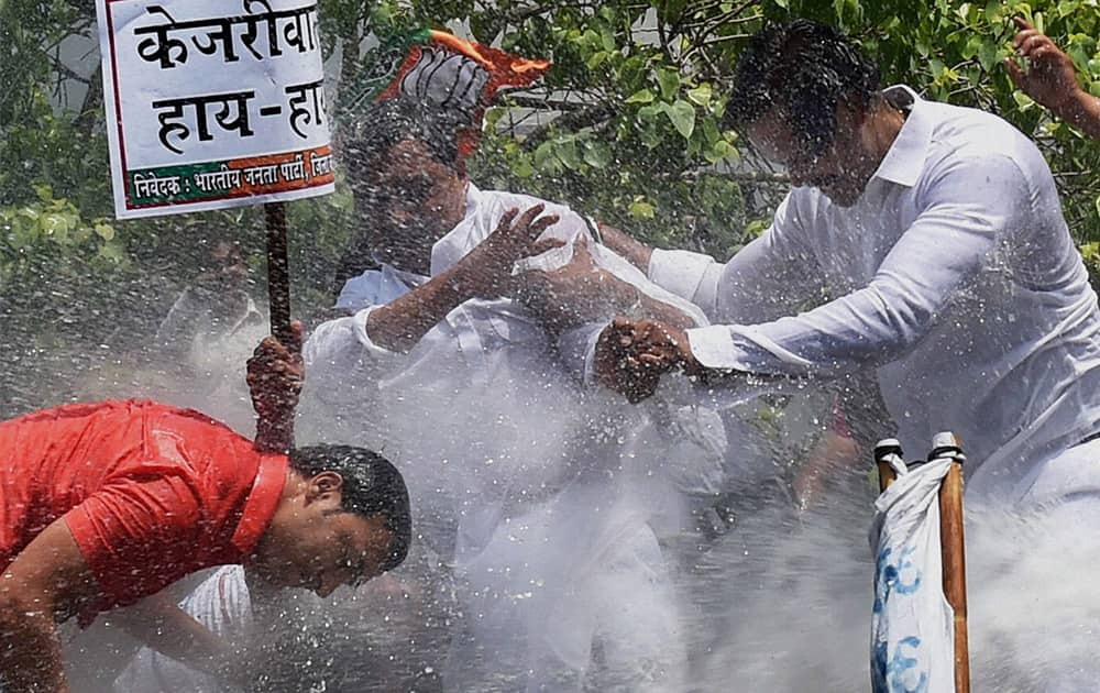 BJP Delhi chief Satish Upadhyay brave water cannons during a protest against Delhi CM Arvind Kejriwal over farmer Gajender Singhs suicide at an AAP rally, in New Delhi.