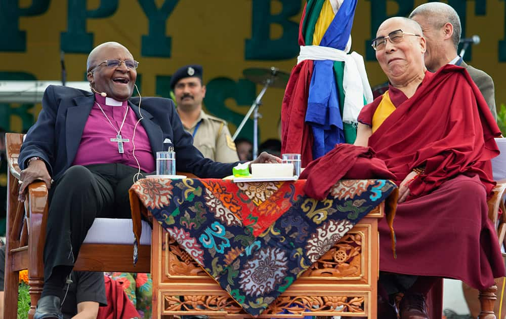 Retired Archbishop Desmond Tutu and Tibetan spiritual leader the Dalai Lama share a lighter moment as they interact with children at the Tibetan Children's Village School in Dharmsala.