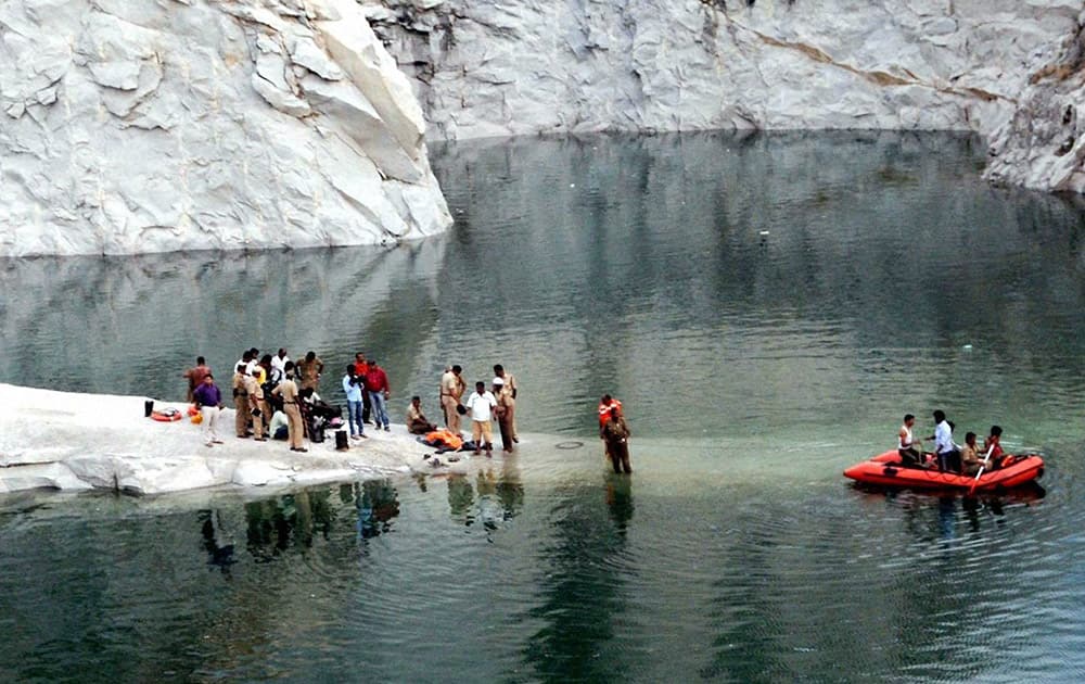 Fire personnel searching for the body of five engineering students from Sri Siddeshwara collage, drowned in a water pool in a quary, at Bettada Halli near Chikkajala, in Bengaluru.