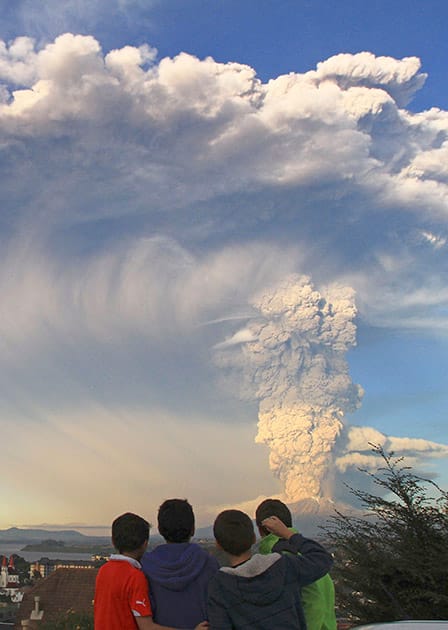 Children watch the Calbuco volcano erupt, from Puerto Varas, Chile.