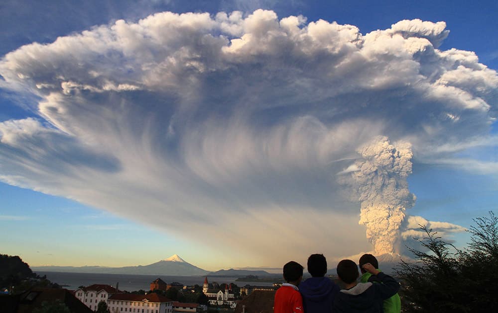 Children watch the Calbuco volcano erupt, from Puerto Varas, Chile.